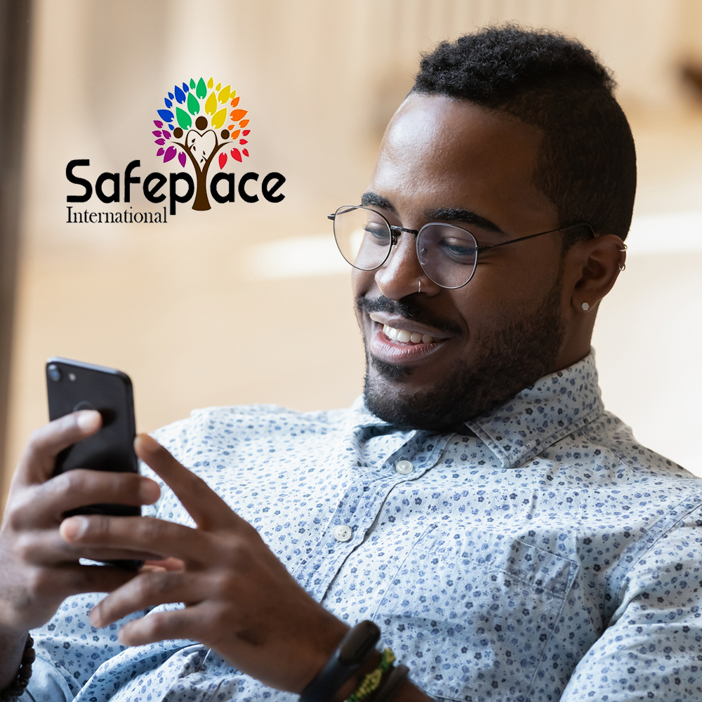 Man smiling at phone with Safe Place International logo in corner